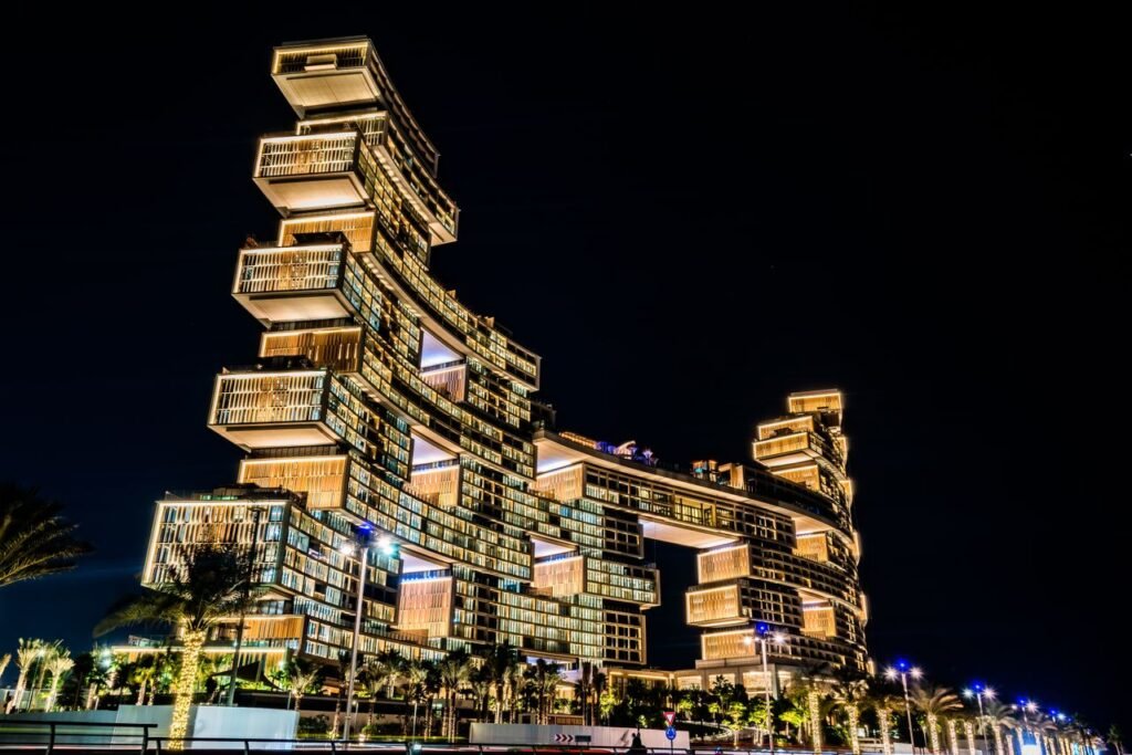 Stunning view of the illuminated Atlantis The Royal Hotel in Dubai, showcasing its modern architecture against the night sky.